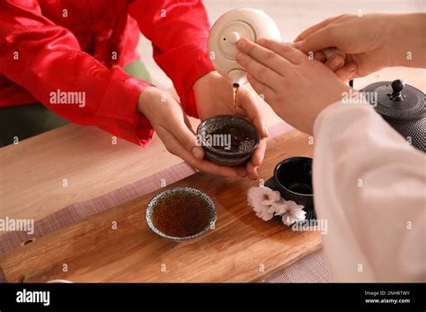 Master Pouring Freshly Brewed Beverage Into Guest S Cup During