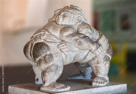 Stone Sculpture Of Two Japanese Professional Sumo Wrestlers Wrestling With A Traditional