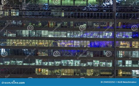 Frontal View of Night Facade of Building with a Lot of Windows with ...