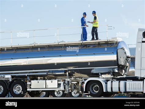 Workers On Platform Above Stainless Steel Milk Tanker Stock Photo Alamy