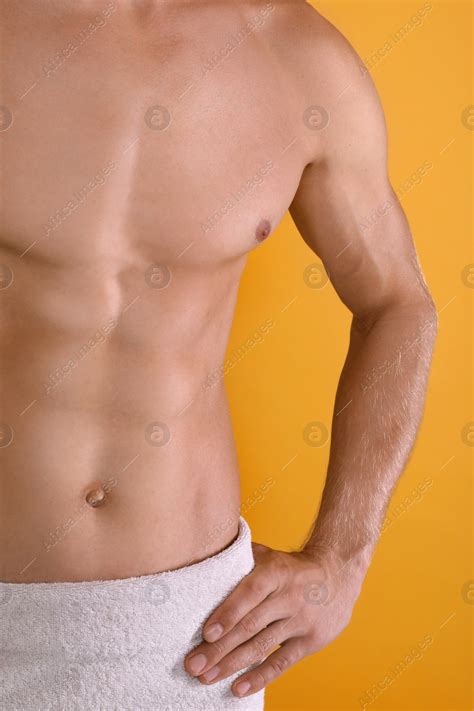 Shirtless Man With Slim Body And Towel Wrapped Around His Hips On