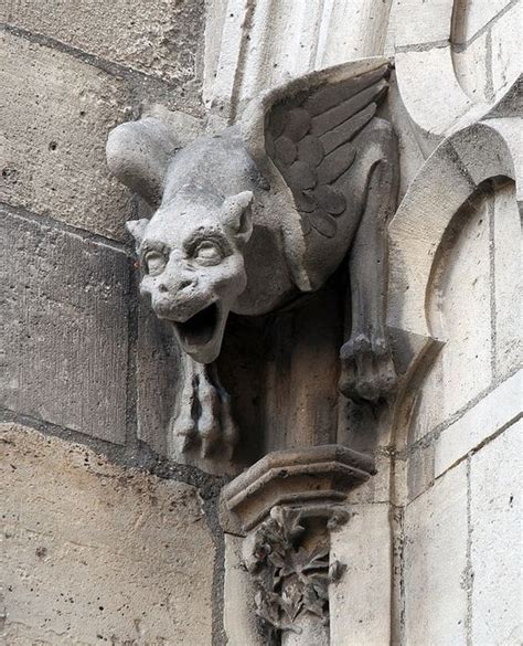 A Gargoyle Head On The Side Of A Building