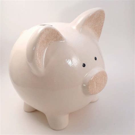 A White Piggy Bank Sitting On Top Of A Table