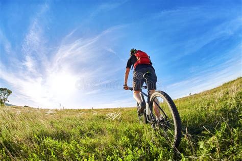 Young Cyclist Riding Mountain Bicyclist Against Beautiful Sunrise In