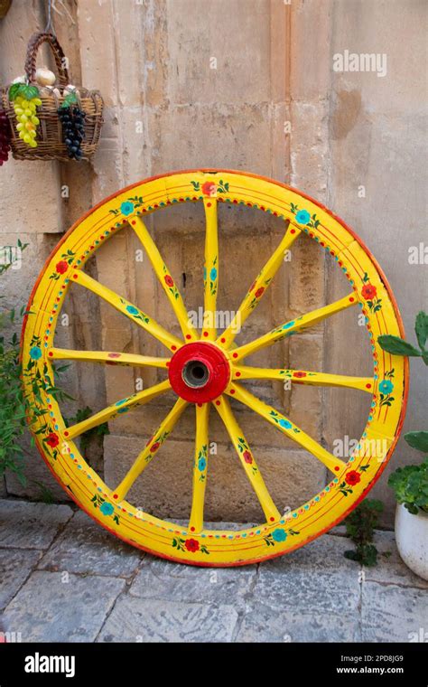 Yellow Wheel Of A Sicilian Traditional Decotated Cart At Ragusa Stock