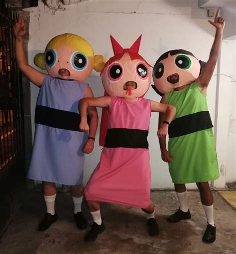 Three People In Costumes Standing Next To Each Other With Their Hands