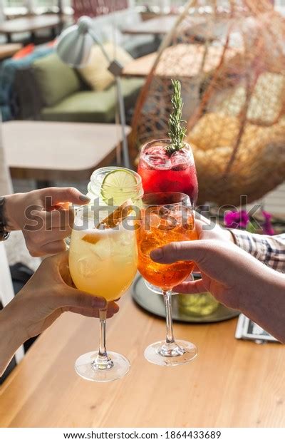 Friends Toasting Saying Cheers Hands Holding Stock Photo 1864433689