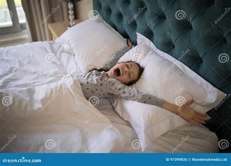 Girl Yawning While Stretching Her Arms In Bed Stock Image Image Of