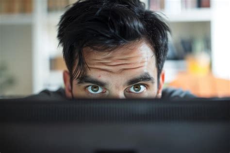 Premium Photo Man Staring Intensely At Computer Screen In Home Office