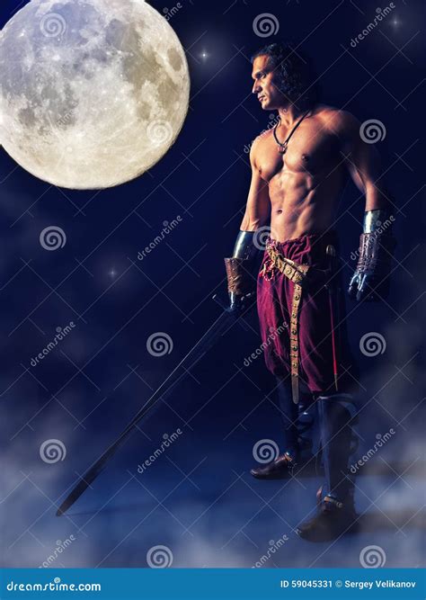 Half Naked Warrior With A Sword In The Mystic Background Stock Image