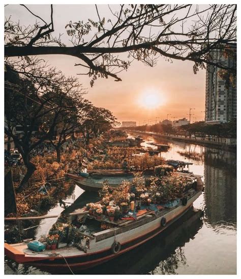 Boats Are Lined Up Along The Riverbank At Sunset