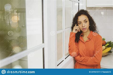 Latin Housewife Stands In The Kitchen Alone In The Kitchen Thinking Something Stock Image