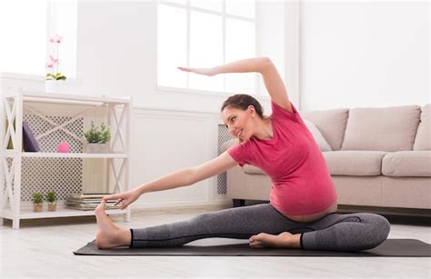 Premium Photo Pregnant Woman Stretching Training At Home Copy Space