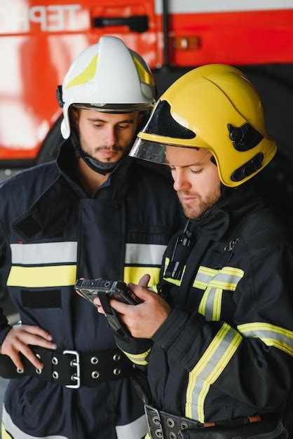 Premium Photo Two Professional Firefighters With Uniforms And