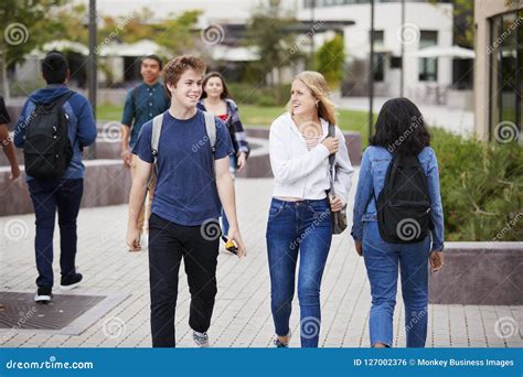 High School Students Socializing Outside College Buildings Stock Photo