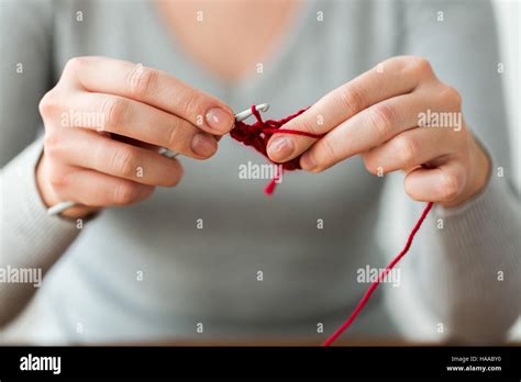 Woman Knitting With Crochet Hook And Red Yarn Stock Photo Alamy