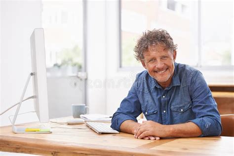 Doing His Best At The Desk A Mature Businessman Sitting At His Office Desk Stock Image Image