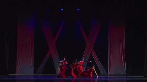 Silhouetted Dancers On Stage With Dramatic Blue Lighting 46440170