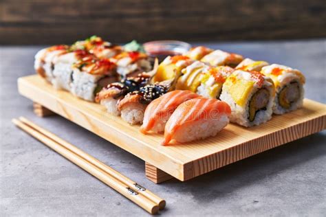 Wooden Board of Sushi Food on a Concrete Surface Stock Image - Image of ...