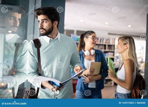 Happy Group Of Friends Studying And Talking Together At University