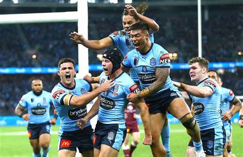 NSW Blues centre and debutant Matt Burton celebrates his first try with his team mates yesterday ...