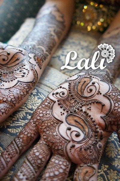 Two Hands With Henna Designs On Them And The Words Lafi Written In White