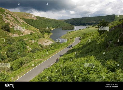 Single Car Driving Along Road In The Elan Valley Near Rhayader Powys