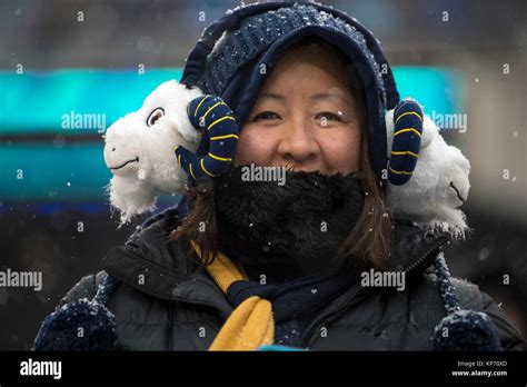 A Navy Fan Wears United States Naval Academy Mascot Earmuffs During The