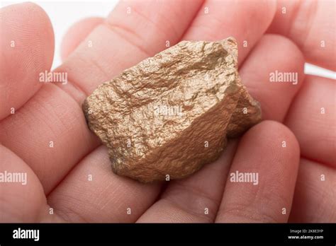 Hand Holding A Little Gold Color Stone In Hand Stock Photo Alamy