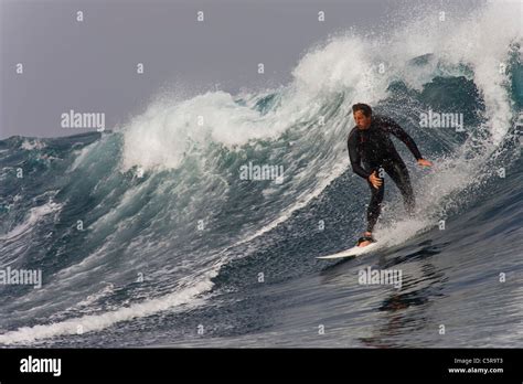 Middle Aged Surfer Riding A Big Wave Stock Photo Alamy