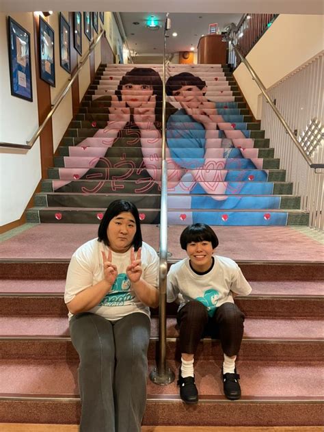 Two People Sitting On The Steps In Front Of Stairs Painted With Images