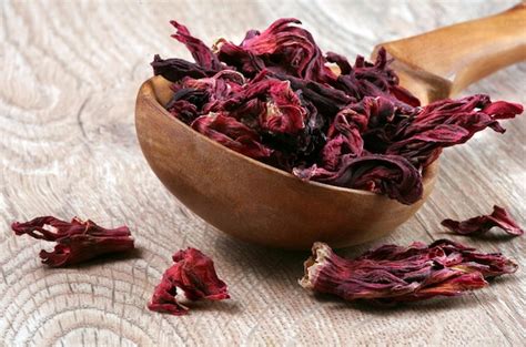 Premium Photo Dried Red Dried Flower Petals In A Wooden Bowl