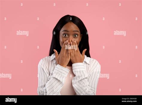 Shocked African American Woman Covering Her Mouth With Hands In