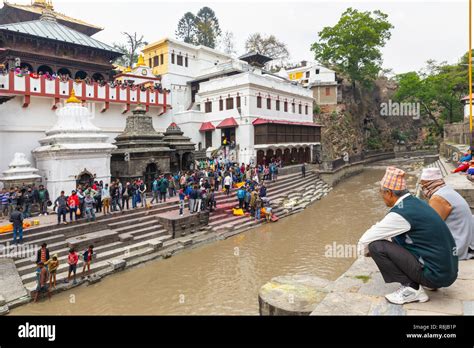 People Watching A Hindu Funeral On The Ghat Upon The Bagmati River At