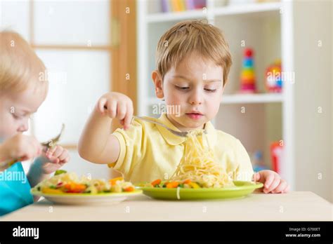 Preschool Children Eat Healthy Food In Kindergarten Stock Photo Alamy