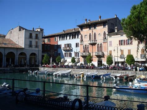 Several Boats Are Docked In The Water Near Buildings