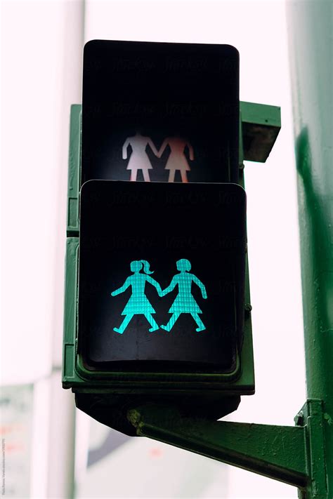 A Traffic Light With Two Women Holding Hands By Stocksy Contributor