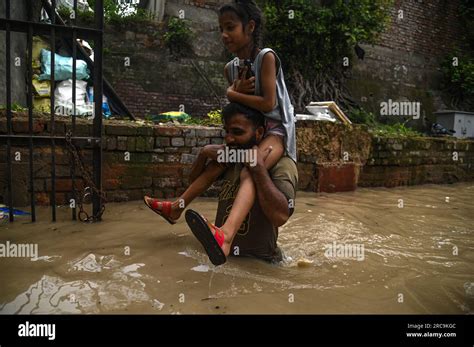 New Delhi Delhi India 13th July 2023 A Man Carries A Girl As They