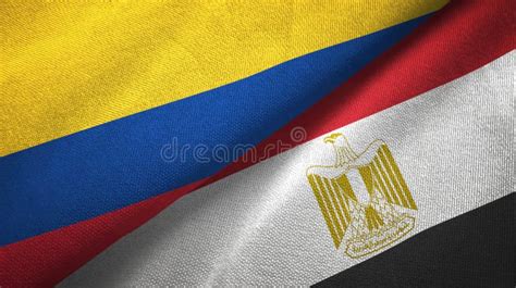 Egypt And Colombia Two Flags On Flagpoles And Blue Cloudy Sky Stock