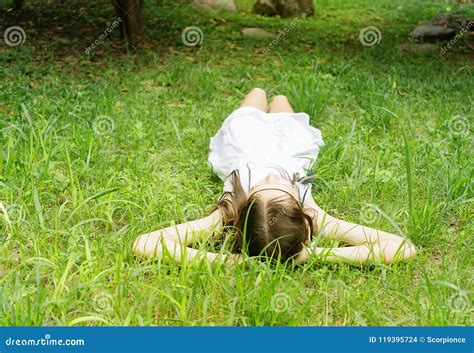 Beautiful Teen Girl In White Dress Lying On Green Grass Boho Style