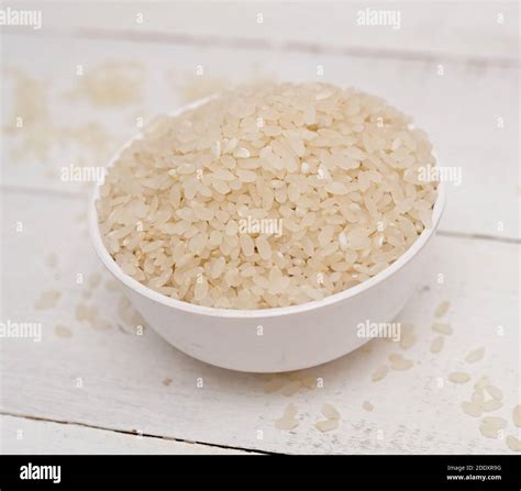 uncooked rice  wooden background stock photo alamy