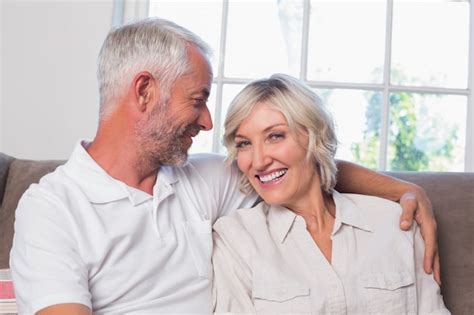 Premium Photo Relaxed Happy Mature Couple Sitting On Couch