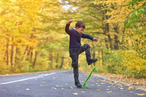 Kid Skateboarder Doing Skateboard Tricks in Autumn Environment Stock Photo - Image of outdoor ...