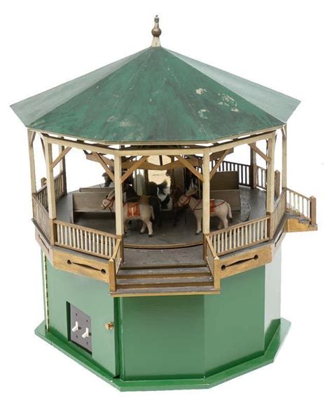 Vintage wooden carousel model with accompanying photographs that ...