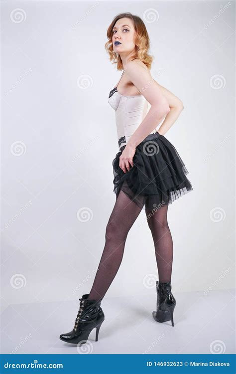 Charming Caucasian Blonde In Lace Beige Lingerie Bodice And Black Skirt