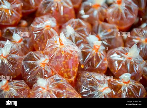 Plastic Bags Filled With Red Thai Chili Pepper Hot Sauce At A Street Food Stall In Bangkok