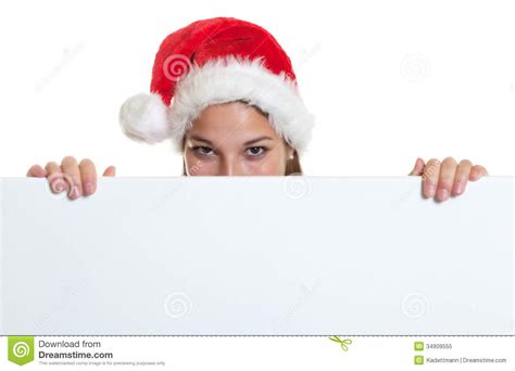 Cheering Woman With Christmas Hat Behind A Signboard Stock Image