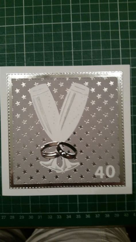 Two Wedding Rings Are Placed In Front Of A Card With The Number On It