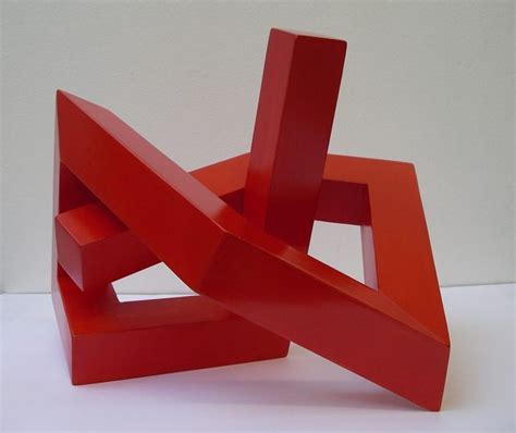 A Red Sculpture Sitting On Top Of A White Table