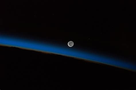 Moon And Earths Atmosphere Seen From International Space Station